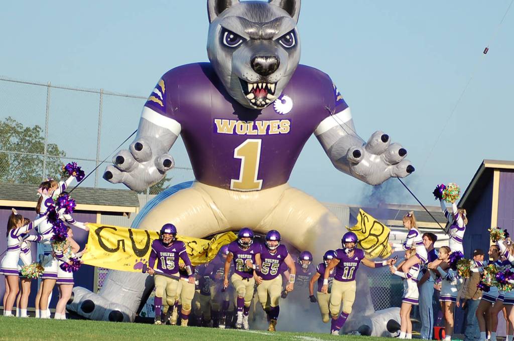 The Sequim Wolves run out of the teams new inflatable tunnel ahead of their non-league game against Washington High School on Sept. 6. Sequim Gazette photo by Conor Dowley