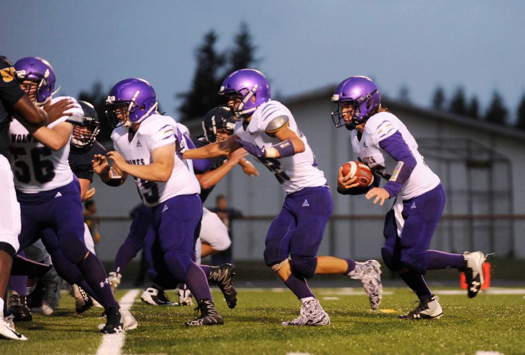 Sequim quarterback Taig Wiker follows a line of blockers toward the end zone in the Wolves 27-13 non-league win at Forks on Sept. 13. Wiker had three touchdown carries in the win. Sequim Gazette photo by Michael Dashiell