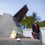 Flowers sit at the base of the I-beam from the World Trade Center in the 9/11 Memorial Waterfront Park during a ceremony in Port Angeles honoring public safety officials on the 18th anniversary of the 9/11 terrorist attacks Wednesday. (Jesse Major/Peninsula Daily News)