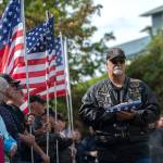 American Legion Rider Ralph Ellsworth presents the American flag during a ceremony in Port Angeles honoring public safety officials on the 18th anniversary of the 9/11 terrorist attacks Wednesday. (Jesse Major/Peninsula Daily News)