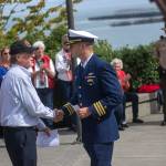 Even organizer Alan Barnard, left, shakes hands with U.S. Coast Guard Air Station Port Angeles Executive Officer Cmdr. Scott Austin during a ceremony in Port Angeles honoring public safety officials on the 18th anniversary of the 9/11 terrorist attacks Wednesday. (Jesse Major/Peninsula Daily News)