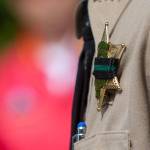 Clallam County Sheriff Bill Benedict wore a band over his badge during a ceremony in Port Angeles honoring public safety officials on the 18th anniversary of the 9/11 terrorist attacks Wednesday. (Jesse Major/Peninsula Daily News)