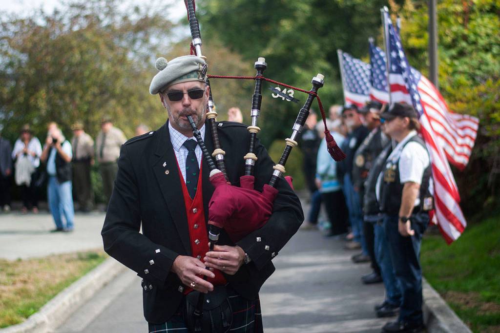 Retired Coast Guardsman Rick McKenzie plays bagpipes during a ceremony in Port Angeles honoring public safety officials on the 18th anniversary of the 9/11 terrorist attacks Wednesday. (Jesse Major/Peninsula Daily News)