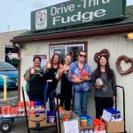 Employees of Clallam County PUD join Christina Norman of WeDo Fudge, far left, at the drive-thrus annual peanut butter drive in August. Submitted photo