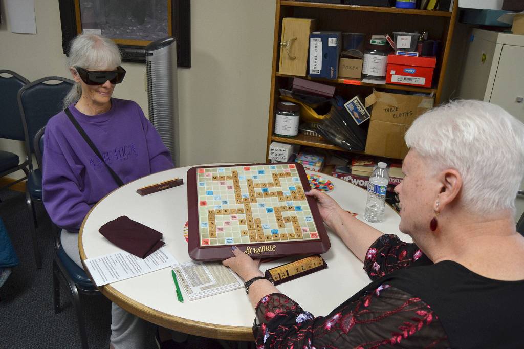 Bobbie Dahn shows her Bingo in a game of Scrabble against Marilyn Van Patter where she opened the game with the word actuate using all seven of her tiles earning 50 additional points. Dahn has led Scrabble for 17 years at Shipley Center. Sequim Gazette photo by Matthew Nash