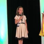 In August, Genevieve Wakefield, 9, introduces herself before judges of the Washington National American Miss pageant. She placed in the top 10, but will compete in the All-American pageant. Photo courtesy of Lula Wakefield