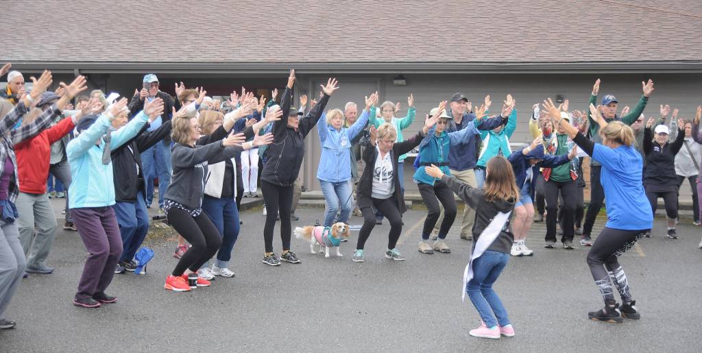 In foreground, Shelley Stratton, right, and Genevieve Wakefield help lead some pre-walk stretches at the Dungeness Valley Health & Wellness Clinic 2019 Fun Walk and Health Fair on Sept. 14. Sequim Gazette photo by Michael Dashiell