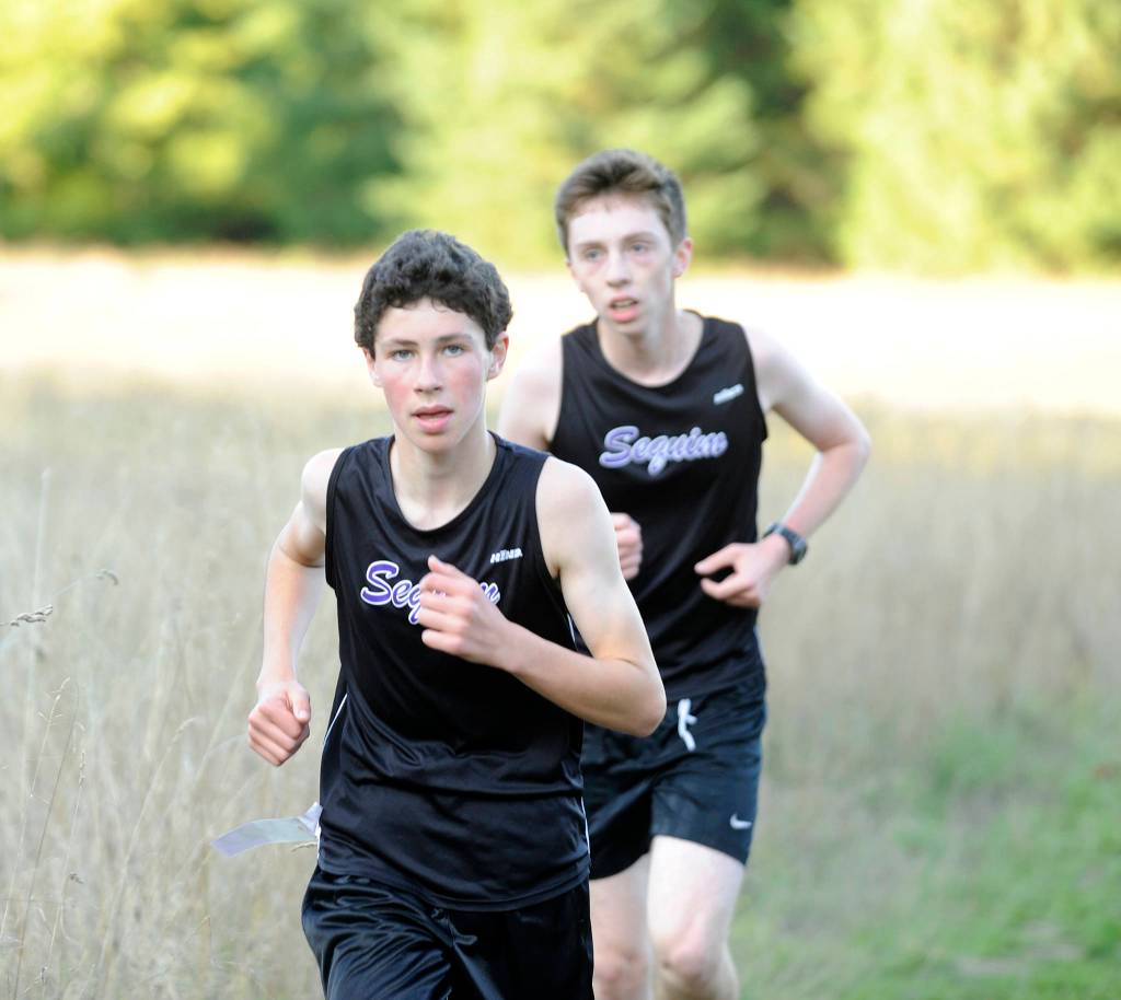 Ayden Humphries, left, and Mikhail Ostrovsky race up Meadow Hill in an Olympic League meet at Robin Hill County Park on Sept. 18. Sequim Gazette photo by Michael Dashiell