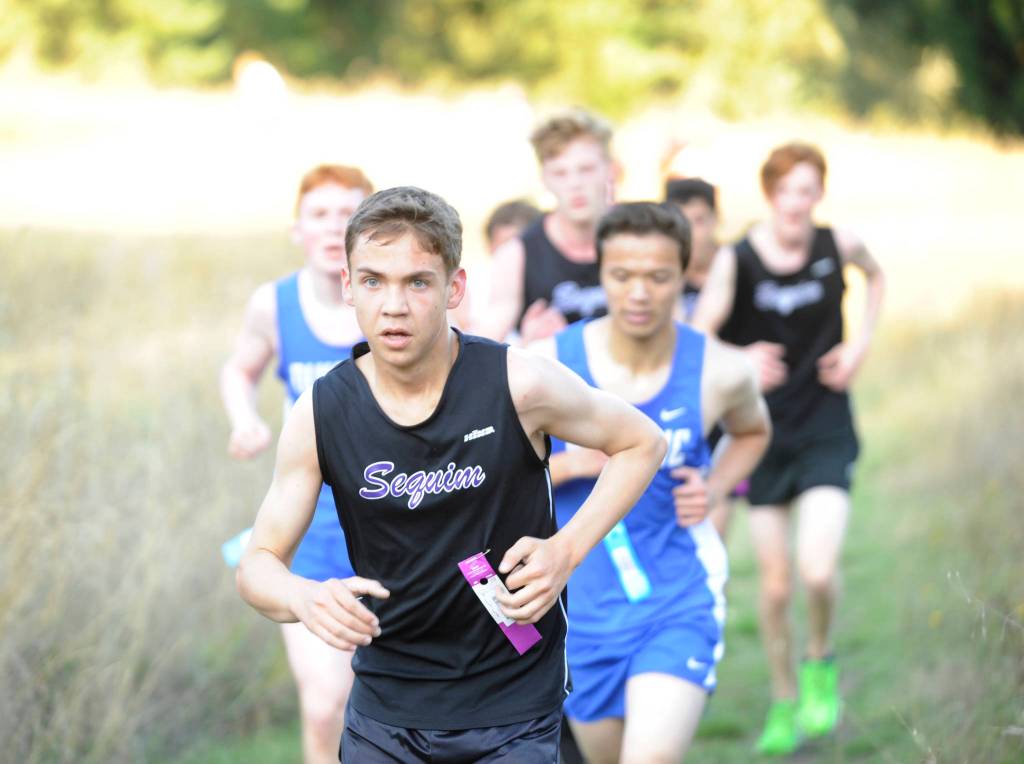 Sequim senior Carson Holt leads a pack up Meadow Hill in an Olympic League meet at Robin Hill County Park on Sept. 18. Holt finished the course in 22:36, 20th overall. Sequim Gazette photo by Michael Dashiell