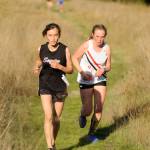 Sequims Macy Cogburn climbs Meadow Hill in an Olympic League meet on Sept. 18 in Sequim, trailed by Camryn Hines of Port Townsend. Cogburn placed sixth overall after finishing the course in 25:53. Sequim Gazette photo by Michael Dashiell