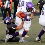 Sequim running back Walker Ward tries to escape the grasp of North Kitsaps Nathan Simms. Ward carried the ball 13 times for 65 yards. Photo courtesy of Mark Krulish/Olympic Peninsula Newsgroup