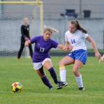 As goalkeeper Olivia Hare, background, looks on, Sequim junior midfielder Natalya James, left, vies for the ball with Bremertons Claire Warthen in the Wolves 4-1 home win over Bremerton on Sept. 17. Sequim Gazette photo by Michael Dashiell