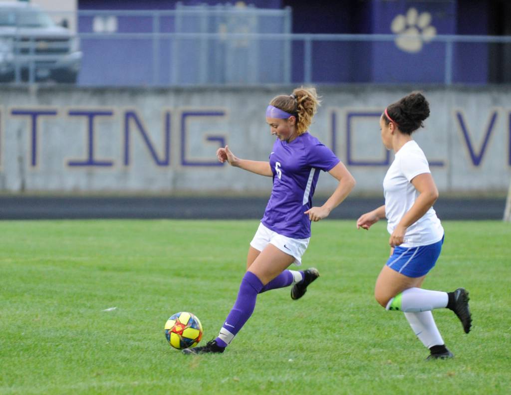 Sequim defender Amara Sayer, left, clears the ball from the Wolves end of the field as Bremertons Ammaya Robinette pursues play, in the first half of an Olympic League match against Bremerton on Sept. 17. Sequim Gazette photo by Michael Dashiell