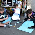 Above, Sequim students Justin Anderson, Sammy Cobb, and Jaden Rinaldo-Hollingsworth cut out fish hats at the North Olympic Salmon Coalitions booth near the Dungeness River Railroad Bridge at last years Dungeness River Festival, which runs 9 a.m.-2 p.m. Friday, Sept. 27. Right, Smokey Bear lines up for a photo for proud grandparent volunteer Mikie Morris at last years Dungeness River Festival. Pictured with Smokey are, from left, Alex Crnic, field ranger for the U.S. Forest Service, Lincoln Terwilliger, Avery Morris, and Sophia Rhynes. Sequim Gazette photos by Matthew Nash
