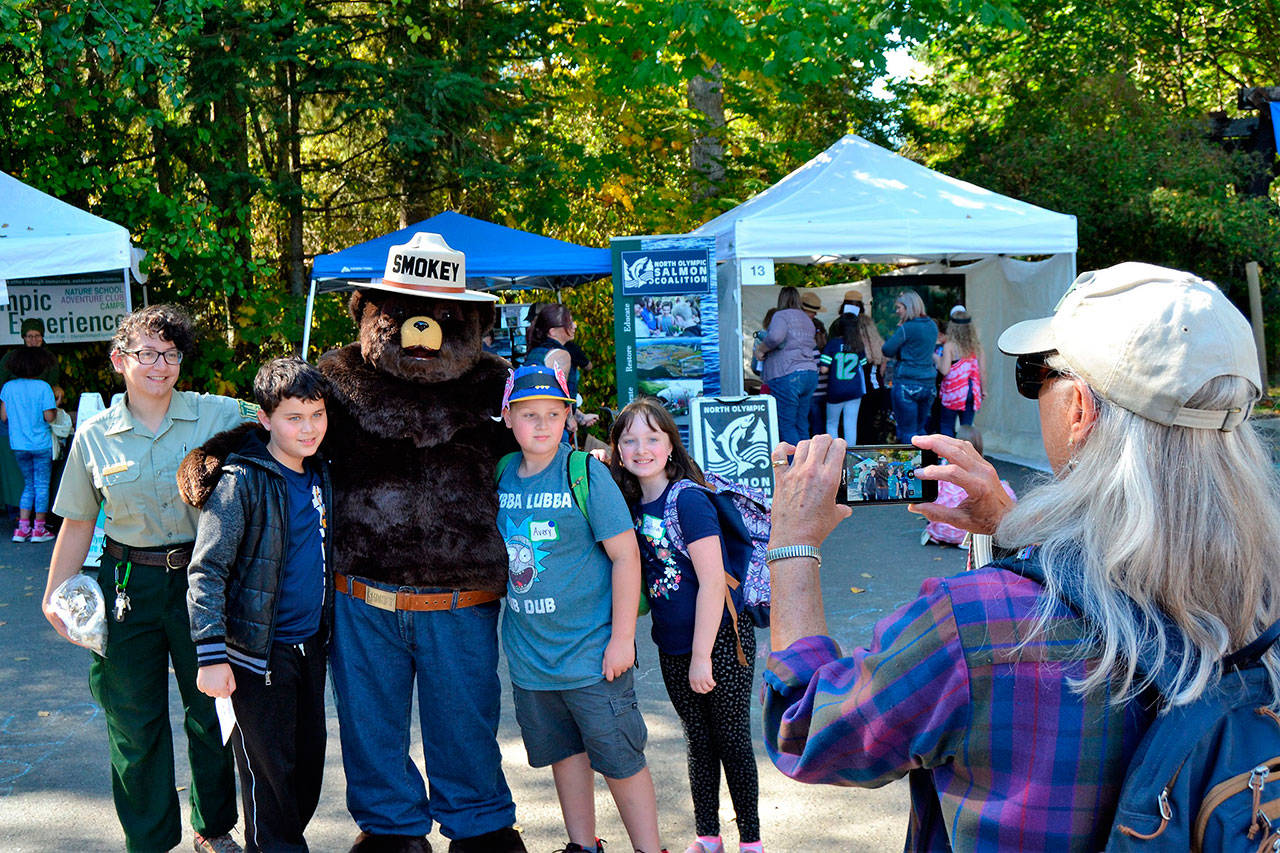 Smokey Bear lines up for a photo for proud grandparent volunteer Mikie Morris at last years Dungeness River Festival. Pictured with Smokey are, from left, Alex Crnic, field ranger for the U.S. Forest Service, Lincoln Terwilliger, Avery Morris, and Sophia Rhynes. Sequim Gazette photo by Matthew Nash