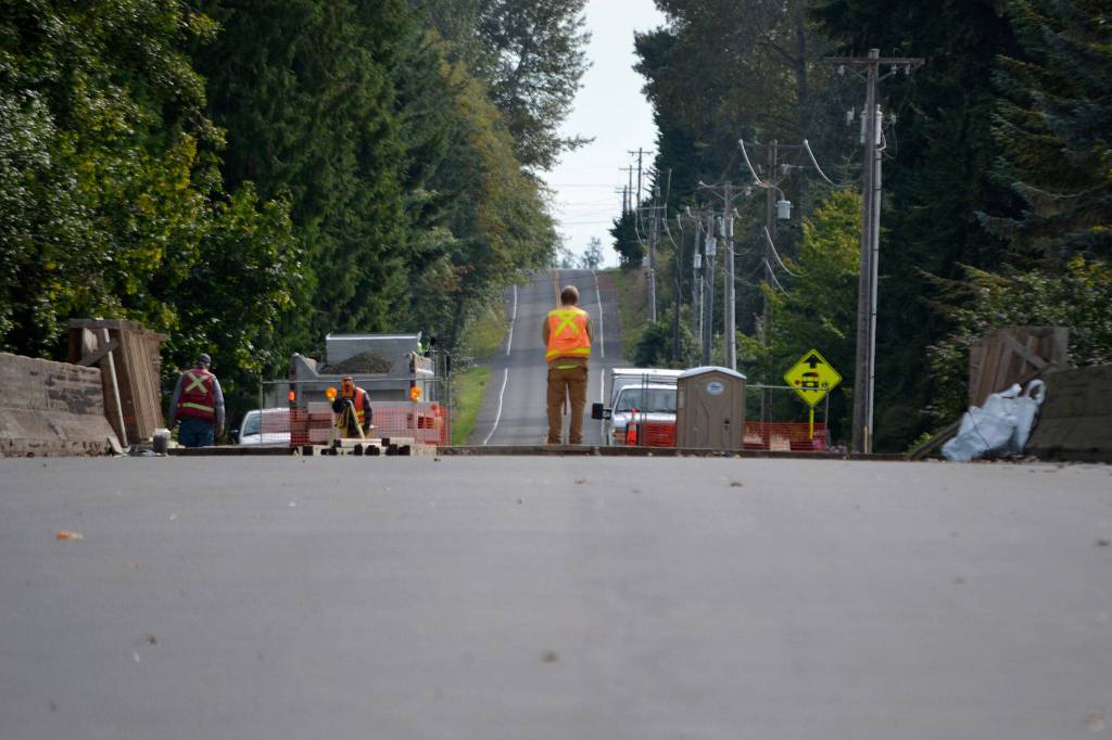 Surveyors with Clallam County begin preparations to repave a section of Woodcock Road over Ward Bridge as construction crews worked to repair it. Sequim Gazette photo by Matthew Nash
