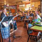 Stephanie Doenges of Bread & Gravy gets an open mic evening started in at the Rainshadow Cafe in August. Photo by Bob Lampert