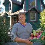 Mark Schwartz, host of Williams Manor and organizer of Applestock, poses in front of the manor with some of the apples from the orchard on the property in 2018. Sequim Gazette file photo