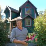 Mark Schwartz, host of Williams Manor and organizer of Applestock, poses in front of the manor with some of the apples from the orchard on the property in 2018. Sequim Gazette file photo