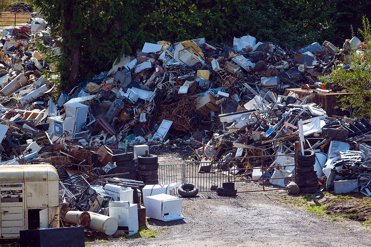 A gate made of metal panels and held together by tires blocks the entrance to Midway Metals between Sequim and Port Angeles on Wednesday. Photo by Jesse Major/Peninsula daily News