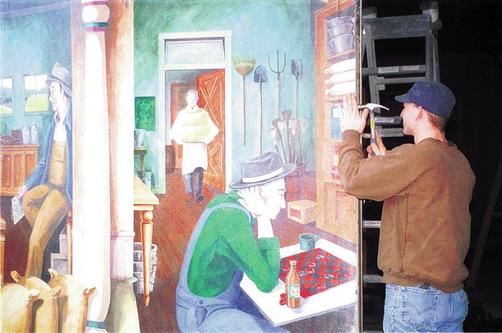 A crew member from Seattle-based Artech, contracted by the Sequim-Dungeness Valley of Commerce to help remove part of the Lehmans mural in March of 2002. Sequim Gazette file photo by Jeff Chew