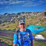 Will Thomas takes a break to enjoy the view of Island Lake in Colorados San Juan Mountains, part of the Hardrock 100 mile race course, in July of 2016. Photo courtesy of Will Thomas