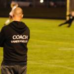 Sequim Wolves head coach Derek Vander Velde watches as goalkeeper Olivia Hale (background right) makes a diving save at the end of the first half of his teams match against North Kitsap. Vander Velde was upbeat after the match despite the loss, praising how well his players came together as a team to come from behind and force a penalty shootout. Sequim Gazette photo by Conor Dowley