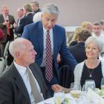 Olympic Medical Center CEO Eric Lewis, back, speaks with Bill and Esther Littlejohn of Sequim at a previous Harvest of Hope event. The Littlejohns will be presented with the Rick Kaps Award, an honor that recognizes organizations and individuals who have supported the Olympic Medical Cancer Center. Photo courtesy of Olympic Medical Center Foundation