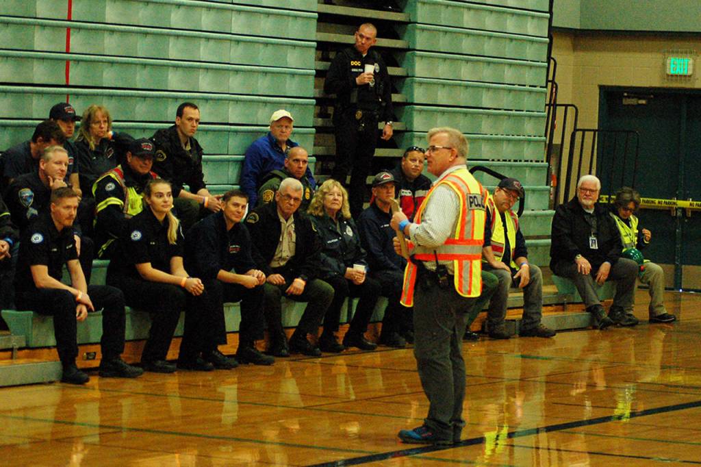 Police sergeant Darrell Nelson briefs the first responders in the Sequim Middle School gym before the Criminal Mass Casualty Incident drill on Sept. 28. Nelson estimated that around 250 people from the dozen agencies involved took part in the drill, more than 100 of which were at SMS including first responders, staff, students, actors and observers.