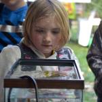 Bayleigh Rollins with Chimacum Elementary listens in on a demonstration from the State Department of Health – Shellfish division about how shellfish absorb items found in the water including glitter that represents pollution. Sequim Gazette photo by Matthew Nash