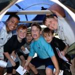 Above, Haylee Noel, 10, a Greywolf fifth grader, pets a cougar inside the Department of Fish and Wildlife booth during the Dungeness River Festival. Haylee said it was the first time she touched a cougar.                                 Left, from left, Myles Taylor, Noah Green, Logan Prendergast, Dakota Domning, Jesse Reeves and Sawyer Tomco, make it to the end of Clallam County Environmental Healths model of a septic tank.
