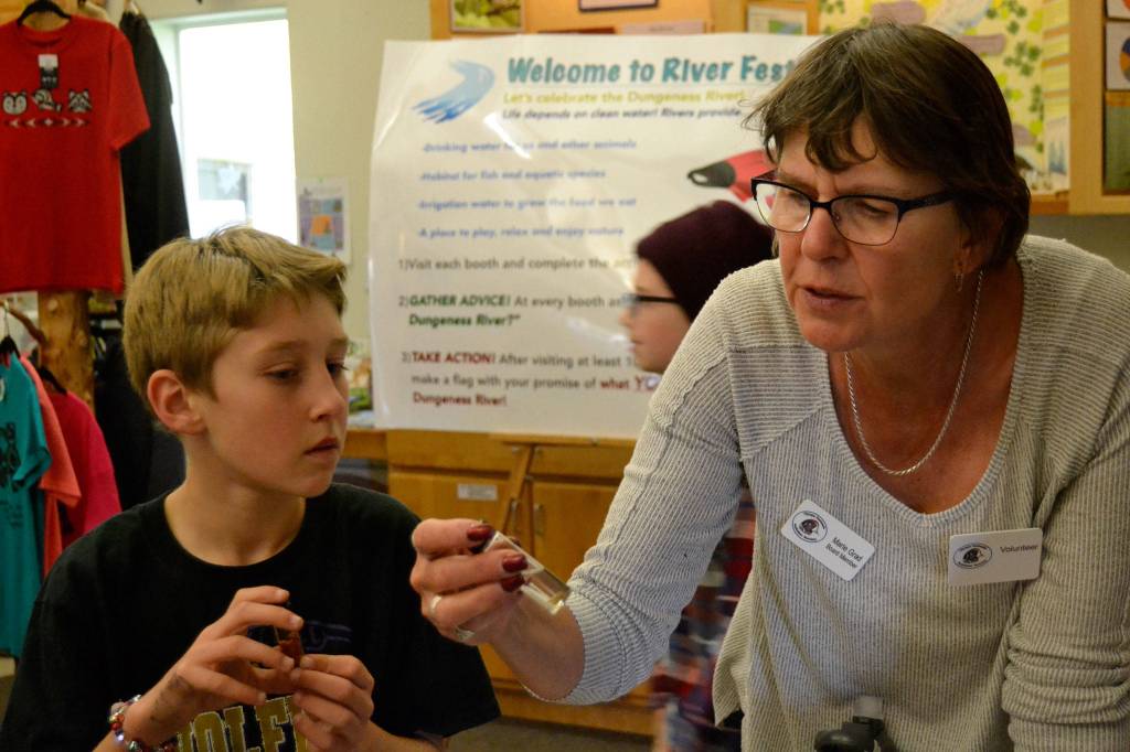 Marie Grad, a River Center volunteer and Olympic Peninsula Audubon Society board member, discusses salmon eggs with Coletyn Hull, 11, a fifth grader at Greywolf Elementary. Sequim Gazette photo by Matthew Nash