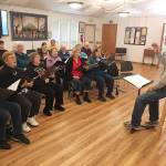 Joel Yelland directs the Interfaith Clallam County Peace Choir in a recent rehearsal. Submitted photo