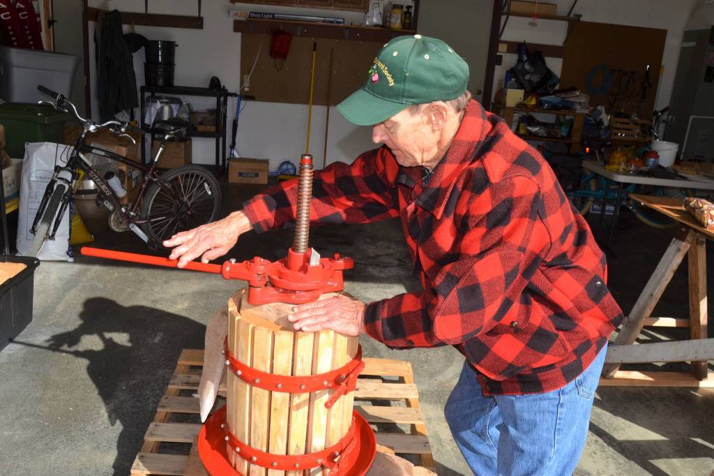 Sequims Alan Kingsbury works his cider press a few times a year. He hopes to press about 14 bottles of cider each year to last him until the next season. Sequim Gazette photo by Matthew Nash
