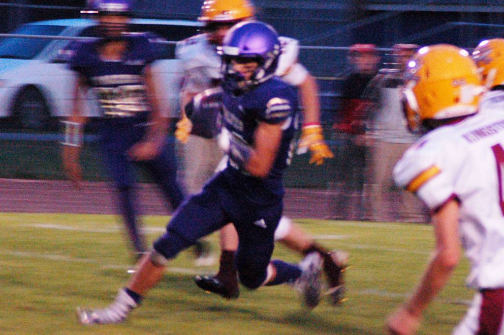 Walker Ward, center, bursts through the line in the first quarter against Kingston. Ward had career highs with 181 yards and three touchdowns, with all three scores coming in the second quarter of Sequims 44-14 Homecoming win over the Buccaneers on Oct. 4. Sequim Gazette photo by Conor Dowley