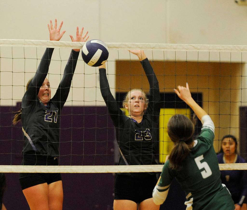 Sequims Kalli Wiker, left, and McKenna Hastings look to block a hit from Port Angeles Emi Halberg. Sequim Gazette photo by Michael Dashiell
