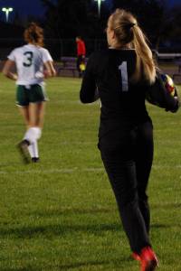 Sequim Wolves goalkeeper Olivia Hare (right, 1) strides forward after collecting the ball in front of goal early in the first half of their win against Port Angeles on Oct. 8. Hare made several big saves during regulation, then stopped all three penalties she faced from the Roughriders in the tiebreaking shootout to secure a big win for the Wolves and the first loss of the season for PA. Sequim Gazette photo by Conor Dowley