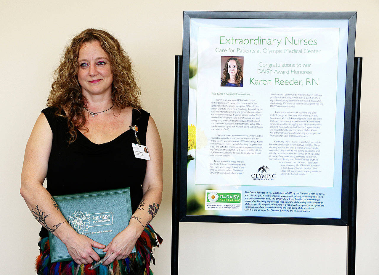 Olympic Medical Center nurse Karen Reeder accepts her DAISY award. Photo courtesy of Olympic Medical Center