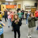Fifth-graders from Brittney Rothwells class practice in music class for an upcoming choir concert in November. Music teacher Laura Lorentzen has them run through a choreographed warm-up song at the beginning of class that includes the Haller Heart hand gesture. Photo by Patsene Dashiell