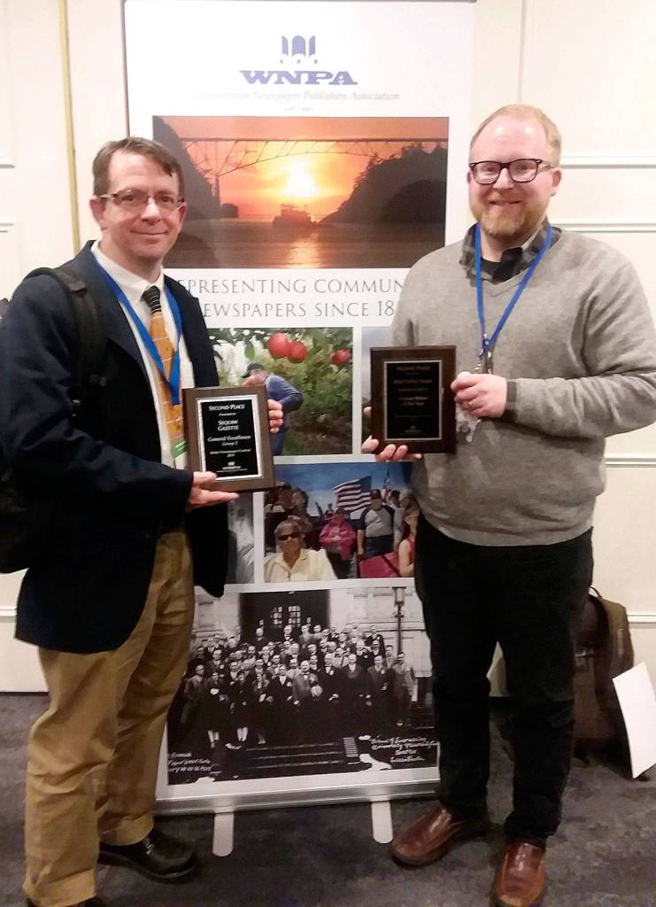 Sequim Gazette editor Michael Dashiell, left, and reporter Matthew Nash celebrate a second place in General Excellence (Division 2) at the Washington Newspaper Publishers Association convention in Olympia in mid-October. Nash took home a second place in WNPAs Feature Writer of the Year. Photo by Patsene Dashiell