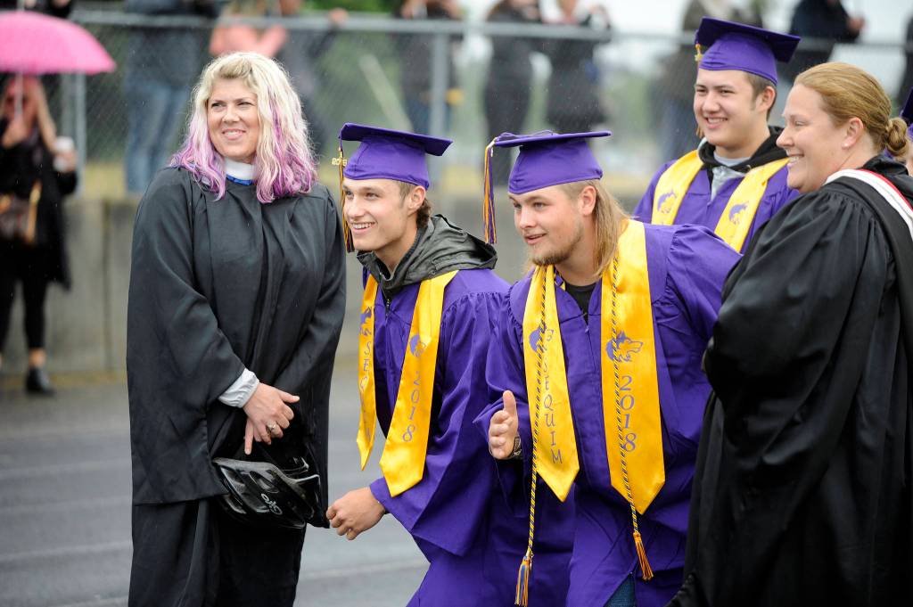 With counselors Melee Vandervelde and Erin Fox and fellow grad-to-be Tyler Smith looking on, Tristan Dodson and Jorden Reed  along with about 190 of their fellow Sequim high School seniors  gear up to graduate on June 8, 2018. The photo earned earned Sequim Gazette editor Michael Dashiell a first place in the Color Feature Photo category at the the Washington Newspaper Publishers Associations 2019 Better Newspaper Contest. Sequim Gazette photo by Michael Dashiell