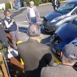 Sequim public works department resource manager Ann Soule, second from left, talks to the crowd after Eric Smith, left, and Walter Wielbicki, third from left, officially started charging their cars as the first two customers of the citys new electric vehicle charging station at the old PUD substation at 410 E. Washington St. on Oct. 11. Sequim Gazette photo by Conor Dowley