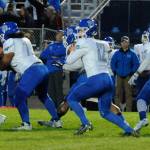 Olympic Trojans senior quarterback Anthony Turso (center, 12) drops back to pass during the first quarter of Olympics 37-14 loss to the Sequim Wolves on Oct. 11. Turso and the Trojans offense were kept fairly quiet on the night, with Turso throwing two interceptions and Olympic losing two fumbles en route to their first Olympic League loss of the season. Sequim Gazette photo by Conor Dowley