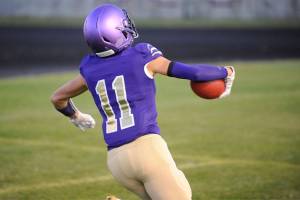 Sequim junior wide receiver Michael Young celebrates as he crosses the goal line to score a touchdown on the Wolves first drive of the game against the Olympic Trojans on Oct. 11. Sequim would go on to win the game 37-14, with Young adding a second receiving touchdown and a key interception on defense. Sequim Gazette photo by Conor Dowley