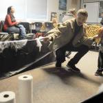 Scarlet Glavin of Sequim tries her hand at the ring toss as Kody Nash looks on at the 2018 Prairie Granges Country Fair.