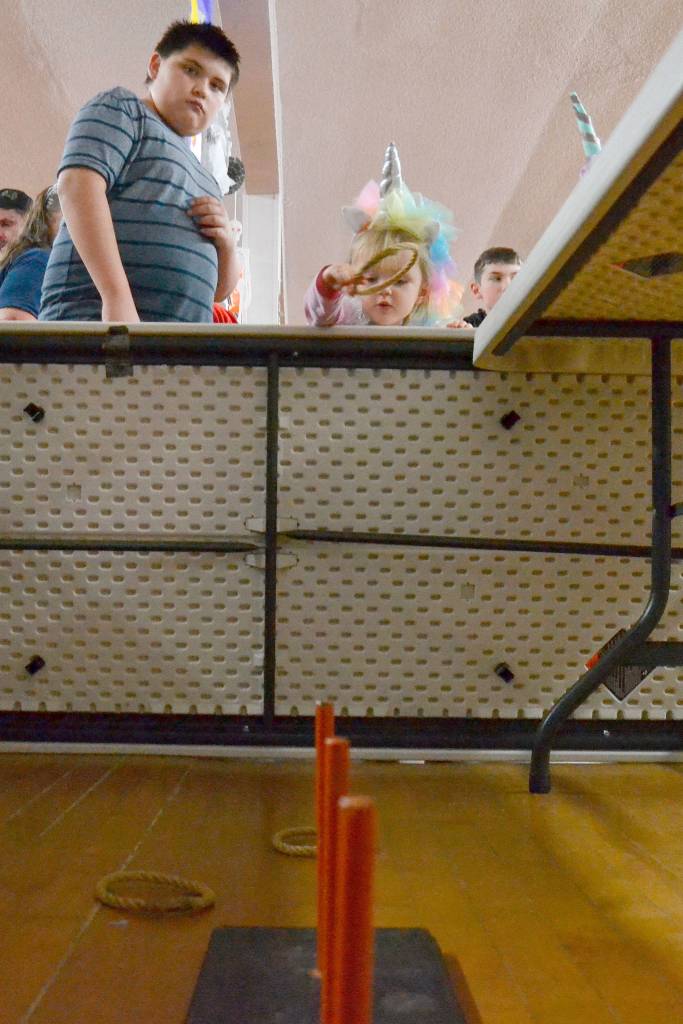 Scarlet Glavin of Sequim tries her hand at the ring toss as Kody Nash looks on at the Sequim Prairie Granges Country Fair in 2018. The event continues this year on Oct. 26. Sequim Gazette file photo by Matthew Nash