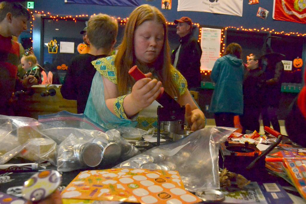 Ayla Smith, a club member at the Boys & Girls Club, makes buttons for the Sequim clubs Halloween event last year. The event continues this year from 6-9 p.m. Saturday, Oct. 26. Sequim Gazette file photo by Matthew Nash