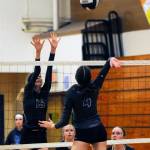 Sequims Kendall Hastings (15) looks to put a block on Olympic hitter Catherine Meikle as teammates McKenna Hastings and Malory Morey, right, look on. Sequim edged the Trojans in five games on Oct. 15. Sequim Gazette photo by Michael Dashiell