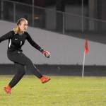 Sequim goalkeeper Olivia Hare boots the ball in the first half of the Wolves 2-1 win over visiting Olympic on Oct. 15. Below, Sequims Daisy Ryan, center, gets swarmed by teammates Jessica Dietzman (12) and Natalya James after she scored a goal mere seconds into the second half. Sequim Gazette photos by Michael Dashiell