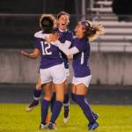 Sequims Daisy Ryan, center, gets swarmed by teammates Jessica Dietzman (12) and Natalya James after she scored a goal mere seconds into the second half of the Wolves win over Olympic on Oct. 15. Sequim Gazette photo by Michael Dashiell